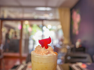 Close up Ice Coffee topping with whip cream and Rose leaf in Coffee cafe