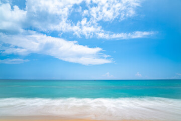Fototapeta na wymiar Seascape of soft wave in tropical sea and sandy beach blue cloud sky.