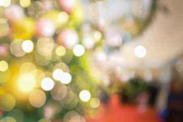 Beautiful bokeh and golden light blurry abstract image of Christmas party and New Year festival interior atmosphere for holiday invitation background.