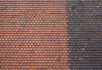 Texture of two separate types of old rare tiles with spots of moss on different houses. Red roof for background