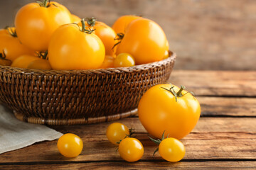 Delicious ripe yellow tomatoes on wooden table