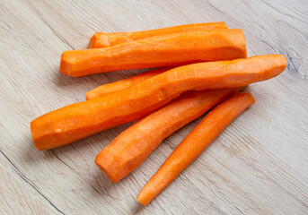 Clean carrots on wood background