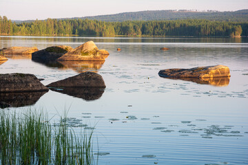 A lake landscape with large boulders in the water