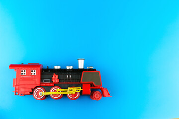Little copy of the locomotive on blue background.