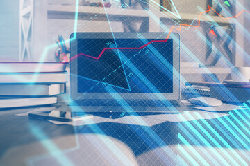 Financial graph colorful drawing and table with computer on background. Double exposure. Concept of international markets.