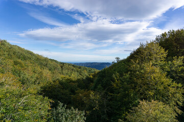 Landscape of mountains in autumn and the Mediterranean sea on the horizon
