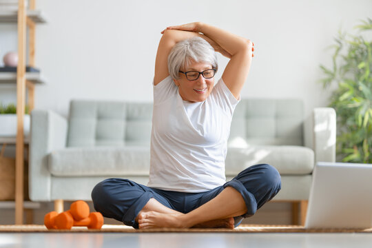 Senior woman exercising at home.