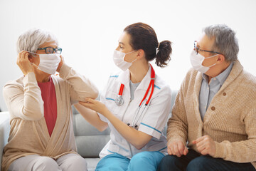 Doctor and senior couple wearing facemasks