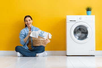 woman is doing laundry - obrazy, fototapety, plakaty
