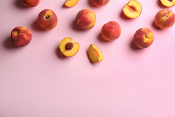 Fresh ripe peaches on pink background, flat lay. Space for text