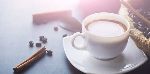 Coffee beans with green leaves for cooking. Bag of coffee. Coffee beans roasted on the table.