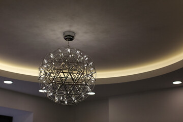 LED modern metal chandelier on the ceiling.