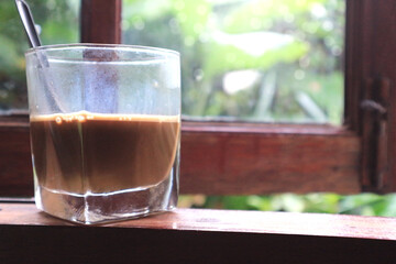 cup hot coffee on table wooden window with natural background