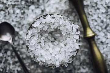 Large sea salt. Spice. Mortar and pestle for grinding.