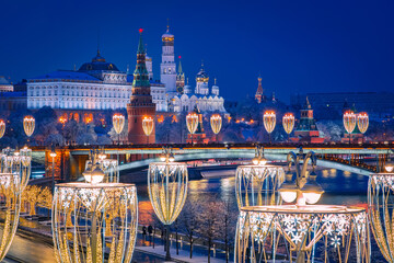 Christmas evening in Moscow. Festive decorations on the background of the Moscow Kremlin. New year in the capital of Russia. Glowing garlands near the Moscow river.