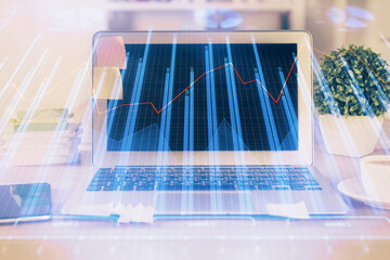 Double exposure of graph and financial info and work space with computer background. Concept of international online trading.
