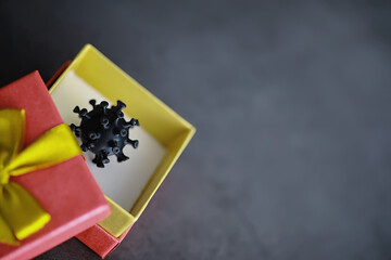 The concept of the world coronavirus pandemic. The geographical location of the virus. China flag and virus model and gift box.