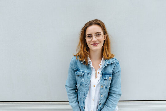 Friendly relaxed young woman in a denim jacket