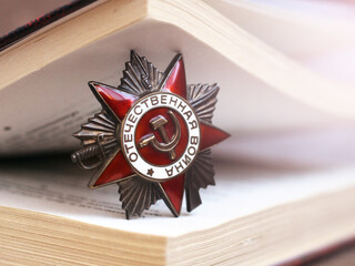 Victory Day Star Order and open book, sunlight toned