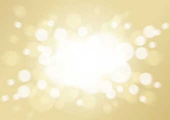 優しい中心から飛び散る光輝く背景玉ボケ　ゴールド