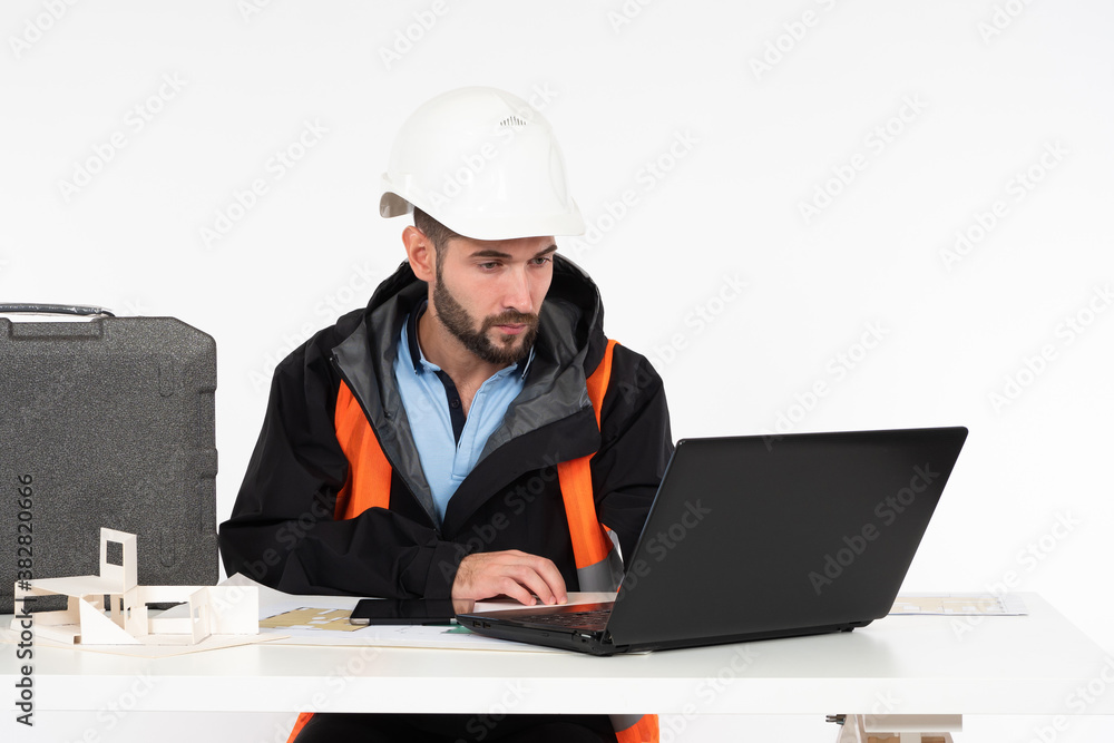 Poster architect at his desk. engineer is working on a construction project. a man in a construction unifor