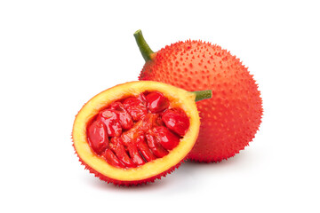 Gac fruit with cut in half and green leaf isolated on white background.
