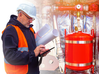 Fire safety. Checking fire-fighting equipment. A safety engineer checks fire extinguishers and...