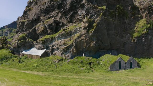 Aerial, pov, classic turf houses on a sunny day, Iceland