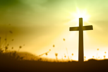 Ascension day concept: The cross on meadow autumn sunrise background
