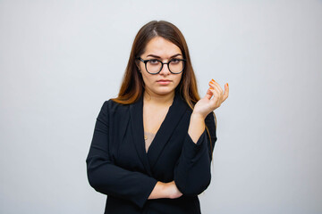 Beautiful girl close-up on grey background in glasses emotions