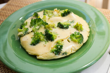 wholesome breakfast. omelet with broccoli on green plate