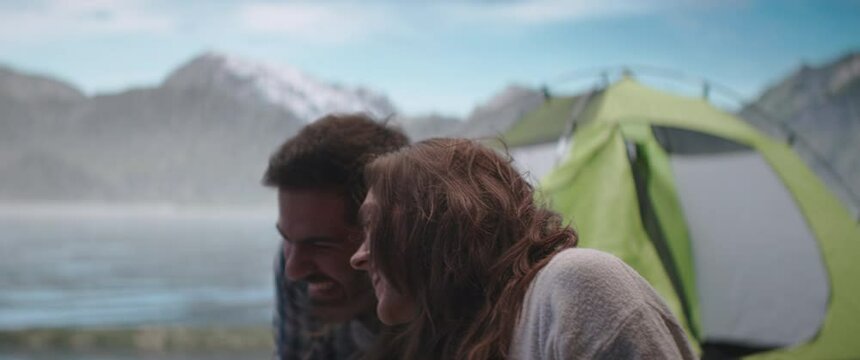 Couple making selfie near the tent during mountain hike. Shot on RED Dragon cinema camera