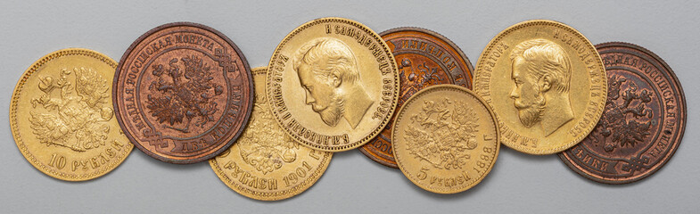 Numismatics. Old collectible coins made of silver, gold and copper on a wooden table.