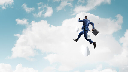 Obraz na płótnie Canvas Businessman jumping high in the air