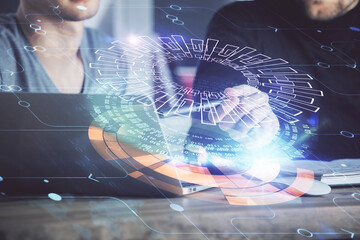 Multi exposure of data internet theme hologram with man working on computer on background. Concept of innovation.
