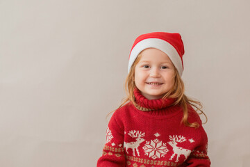 Happy Redhair girl in christmas jacket and santa hat 