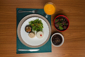 traditional Brazilian feijoada with orange juice