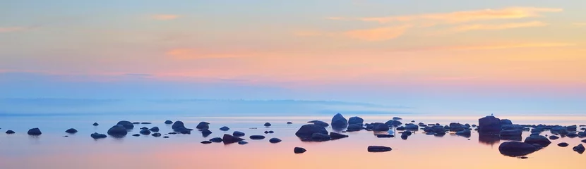 Fotobehang Slaapkamer Rocks at the coast of Kasmu (captain's village) at sunset. Estonia, Baltic sea. Clear blue sky, pink clouds. Panoramic view. Travel destinations, vacations, eco tourism  © Alex Stemmer
