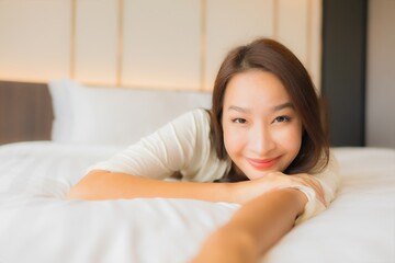 Obraz na płótnie Canvas Portrait beautiful young asian woman smile relax on bed in bedroom interior