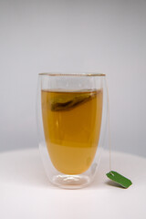 in one glass there is tea and a tea bag
