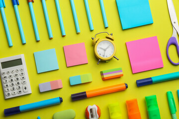 Flat lay composition with school stationery on yellow background. Back to school