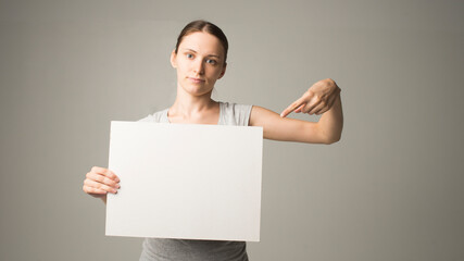 woman holding a sheet of paper in her hand