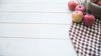 apples in a bag on a wooden background, free space for text