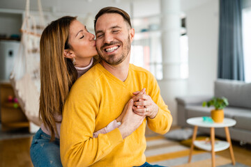 Fototapeta premium Beautiful couple in love is enjoying the company of each other at home.