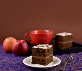 Apple chocolate cake brown frame stock images. Apple chocolate pie isolated on a brown background with copy space for text. Apple chocolate cake brown border. Cake with apples still life stock photo