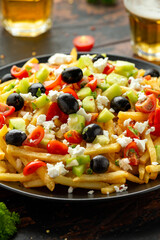 Loaded potato Vegan Fries with tomato, cucumber, olives and feta cheese