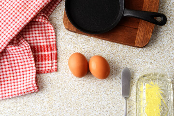  high angle brown eggs with cast iron frying pan and butter