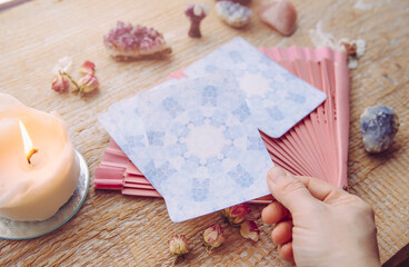 Deck with divination homemade Angel cards on wood table, surrounded with semi precious stones...
