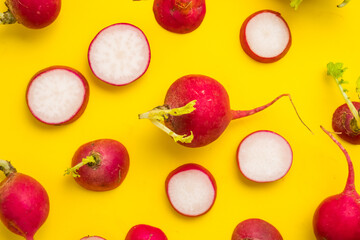 Red ripe sliced radish on yellow background