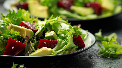 Vegetarian avocado and beet salad in plate. Healthy vegan food